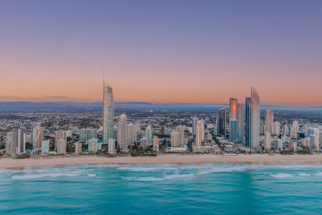 Gold Coast skyline at sunrise with waves rolling onto the beach